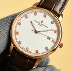 Gold Vacheron Constantin watch with white dial, red diamond markers, black leather strap