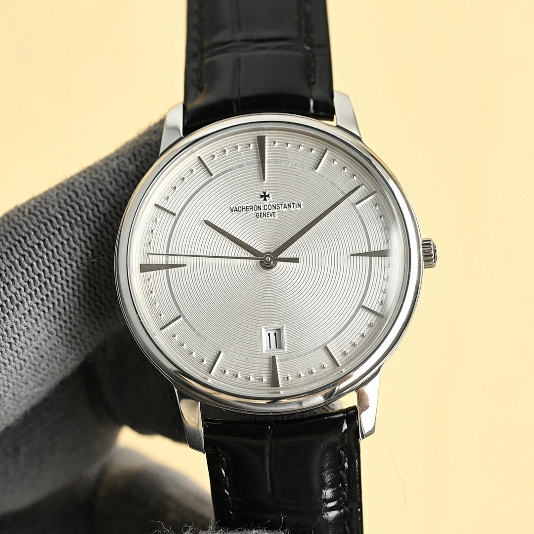 Vacheron Constantin watch with silver dial and black leather strap, round steel case