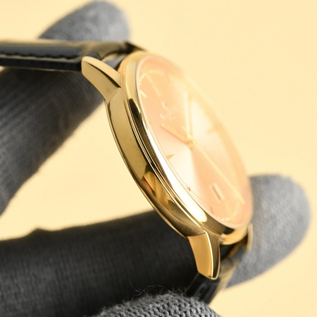 Luxury wristwatch side profile with pale dial, gold case, and black leather strap