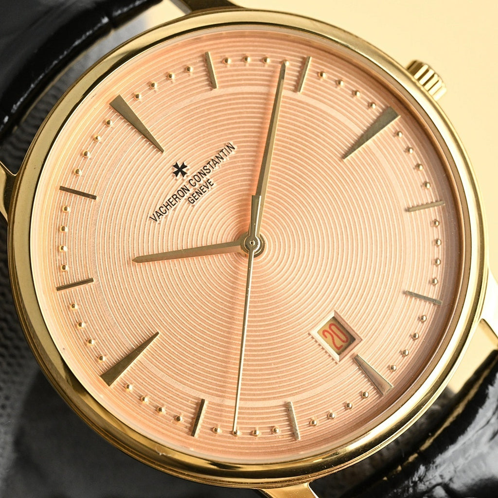 Luxury wristwatch with champagne dial, gold markers, sweeping hands and date window