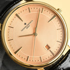 Luxury wristwatch with champagne dial, gold markers, sweeping hands and date window