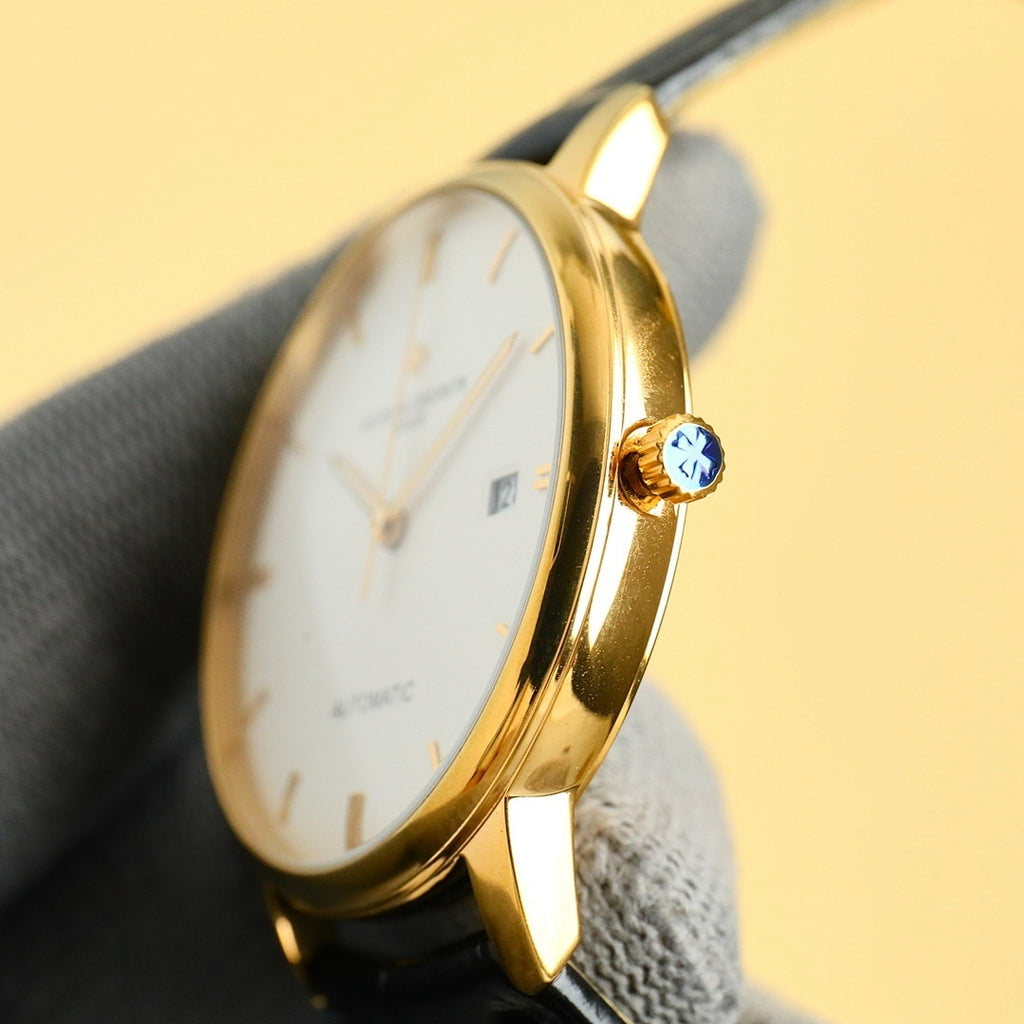Vacheron Constantin wristwatch with gold-tone case, blue jeweled crown, white dial