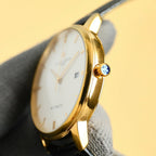 Vacheron Constantin wristwatch with gold-tone case, blue jeweled crown, white dial
