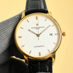 Vacheron Constantin automatic wristwatch with white dial, gold-tone case, date 28, black strap