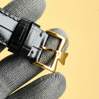 Vacheron Constantin wristwatch strap buckle on black leather strap, gold-tone clasp