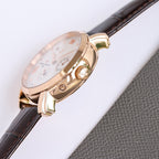 Rose-gold watch case with crown, brown leather strap, white dial with subdials.