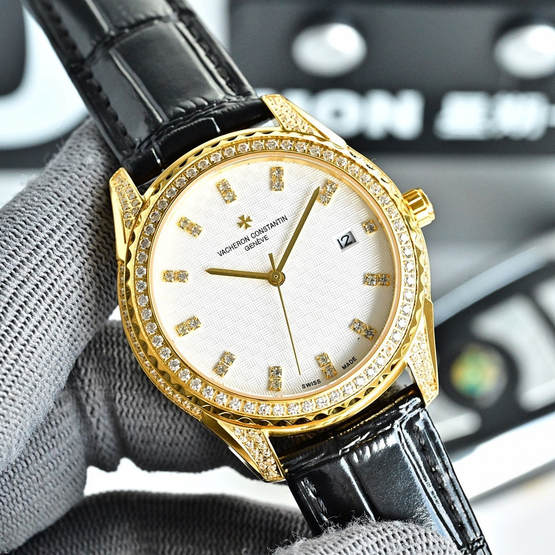 Gold-tone watch with white dial, black leather strap, jeweled bezel, date window