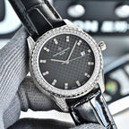 Silver-tone watch with dark textured dial, black leather strap, jeweled bezel, date window