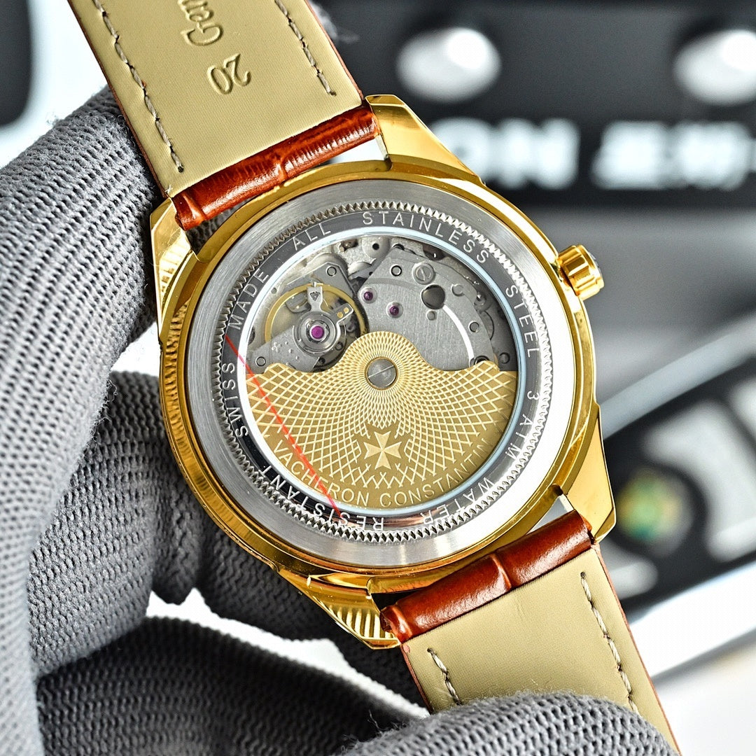Gold-tone watch with engraved caseback, exposed mechanical movement, brown leather strap