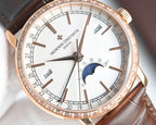 Rose-gold watch close-up: white dial, moonphase, day window, brown leather strap