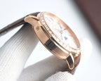 Rose-gold watch case in side profile, crystal bezel and brown leather strap