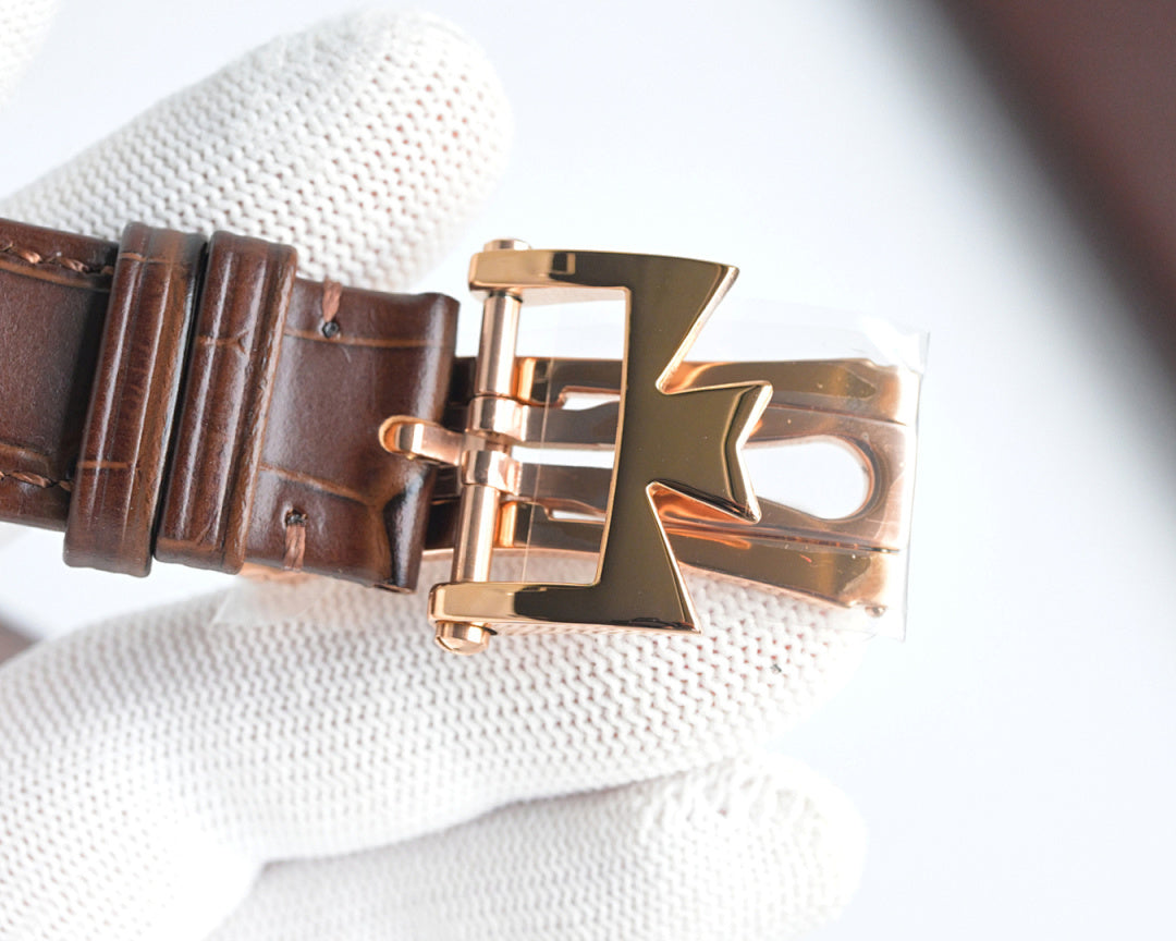 Rose-gold buckle clasp on brown leather watch strap