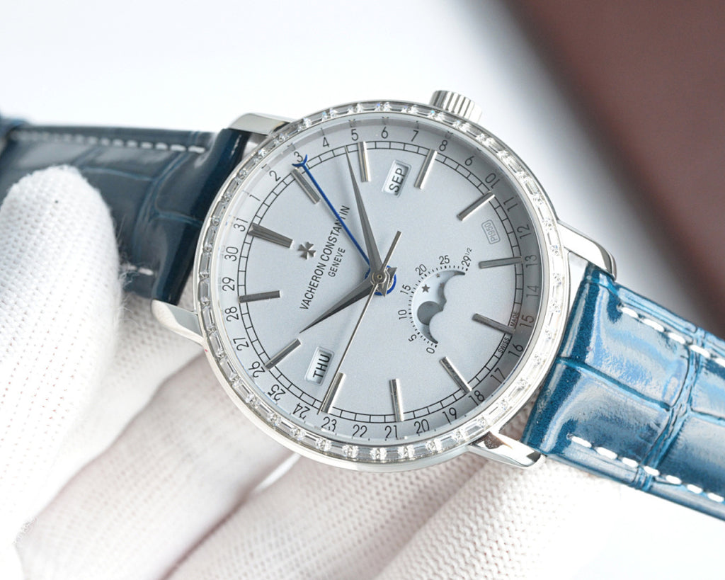 Luxury wristwatch three-quarter view with white dial, silver case, and blue leather strap.