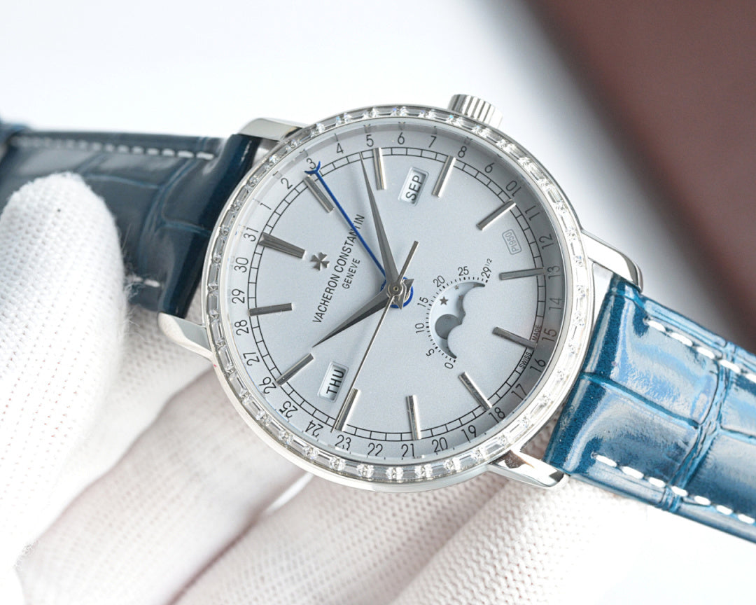 Luxury wristwatch three-quarter view with white dial, silver case, and blue leather strap.