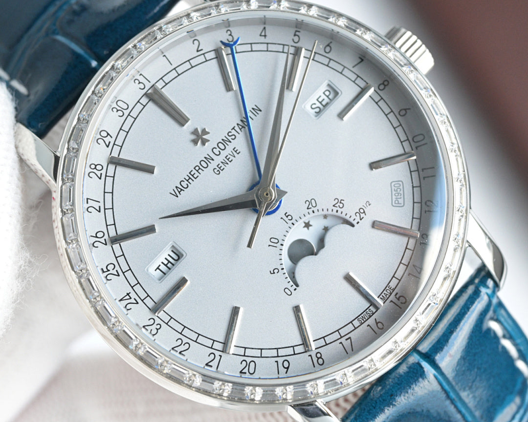 Close-up of luxury wristwatch dial with silver hands, subdial, and blue accents on markers.