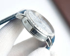 Luxury wristwatch side profile with silver case, polished edges, and blue leather strap.