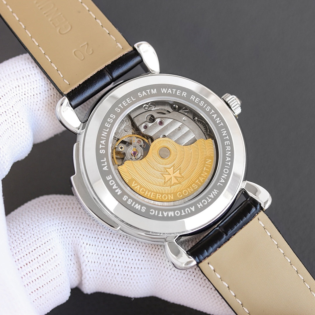 Watch caseback showing engraved text and visible movement with gold-toned circular component