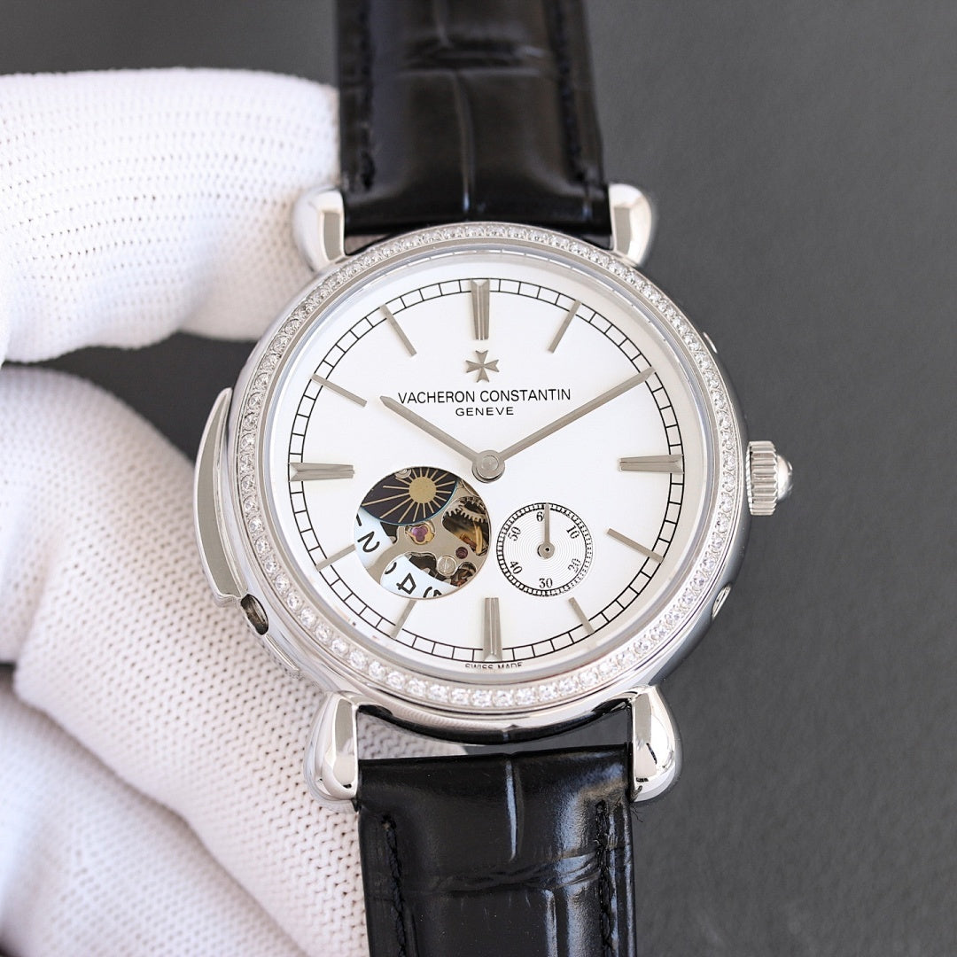 Silver watch with white dial, skeleton-style subdials, and black leather strap with diamond bezel