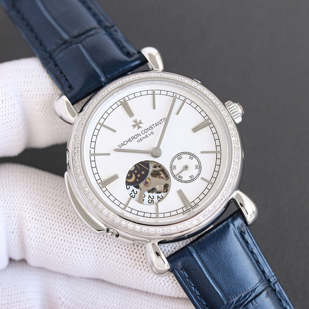 Silver watch with white dial, subdials, and blue leather strap