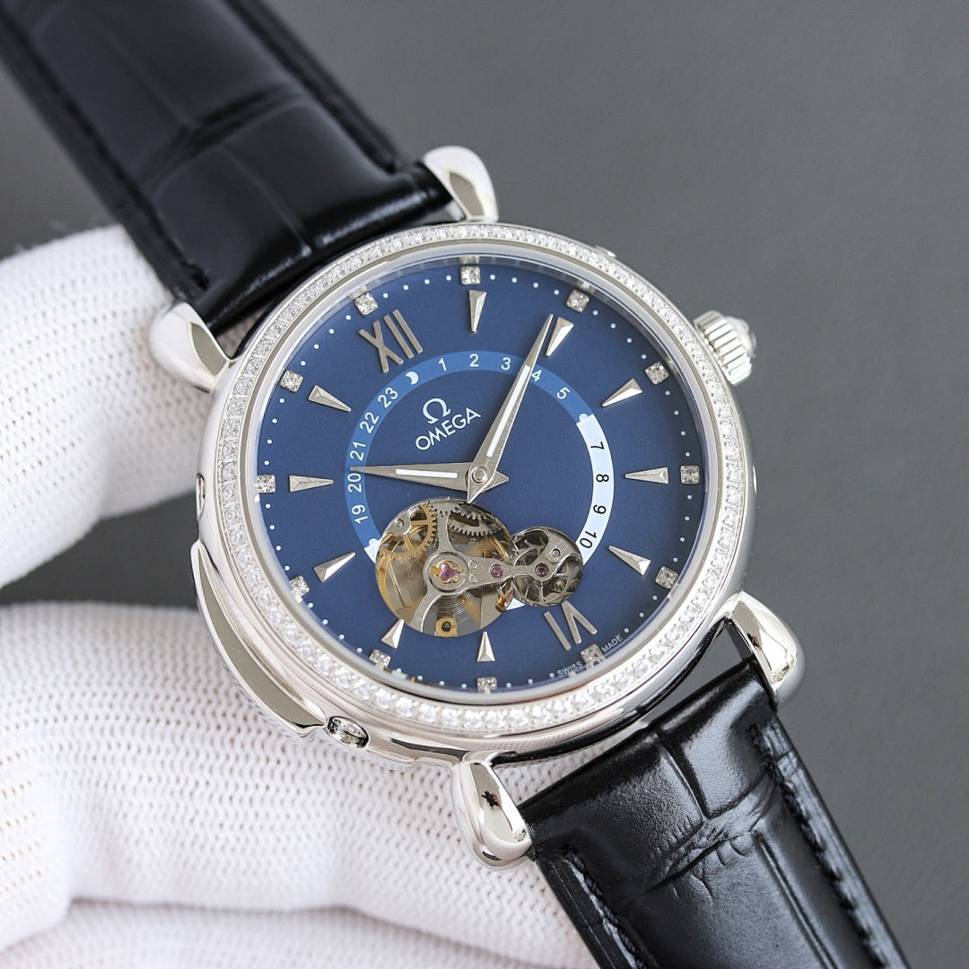Luxury watch with black leather strap, silver case, blue dial, diamond bezel, visible mechanical dial