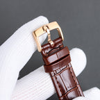 Luxury watch side view with brown leather strap and rose gold-toned case with rounded lugs