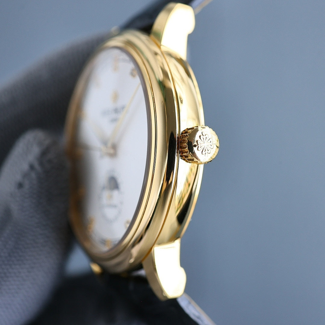 Gold wristwatch side profile with crown detail; leather strap.
