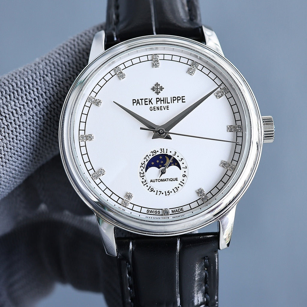 Steel wristwatch with white dial and black leather strap; baton markers and moon-phase subdial.