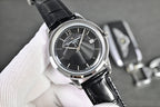 Vacheron Constantin watch with black dial, silver bezel, and black leather strap