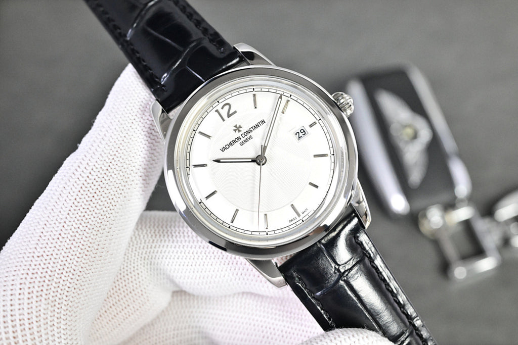 Vacheron Constantin watch with white dial, black leather strap, and silver case