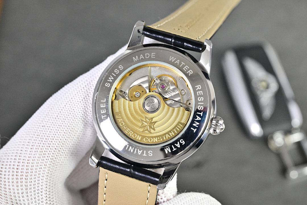 Vacheron Constantin watch caseback with gold-toned movement and black leather strap
