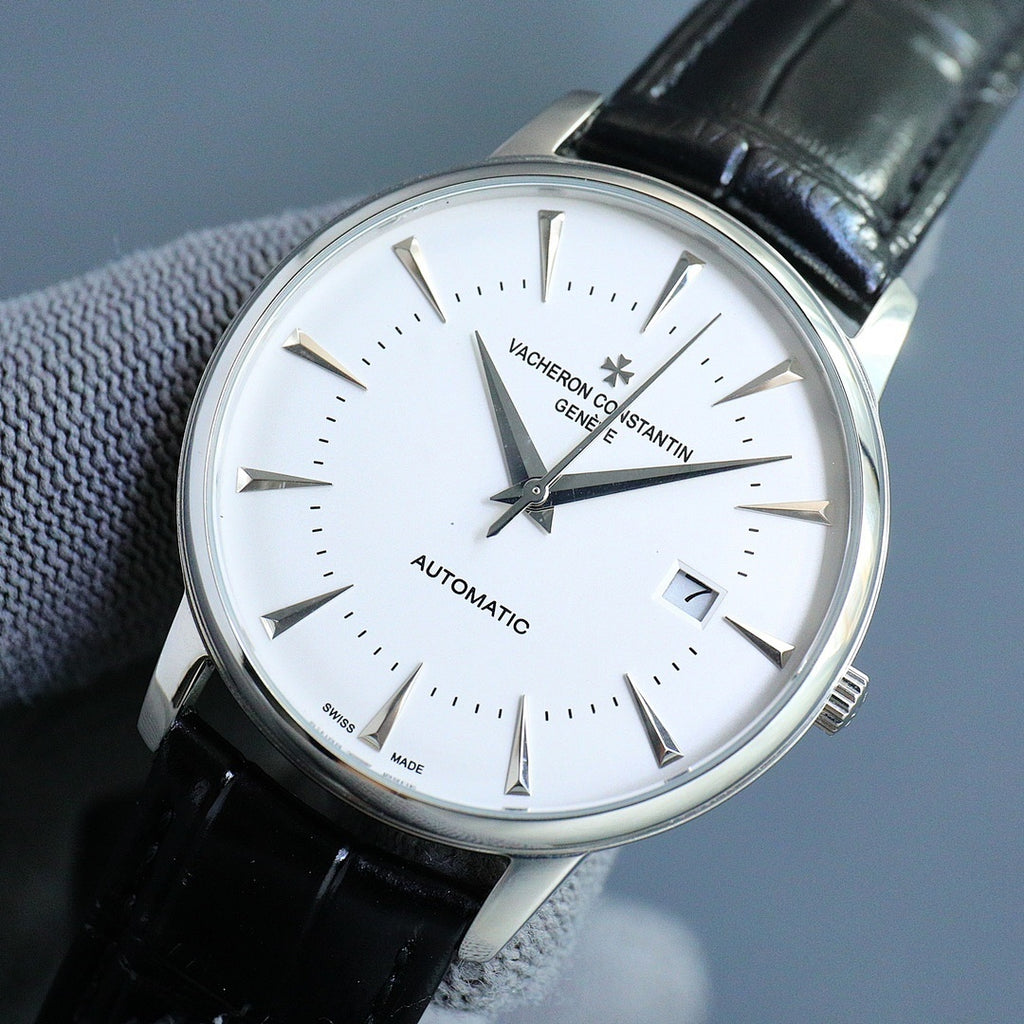Close-up automatic wristwatch with white dial and black leather strap, date at 7