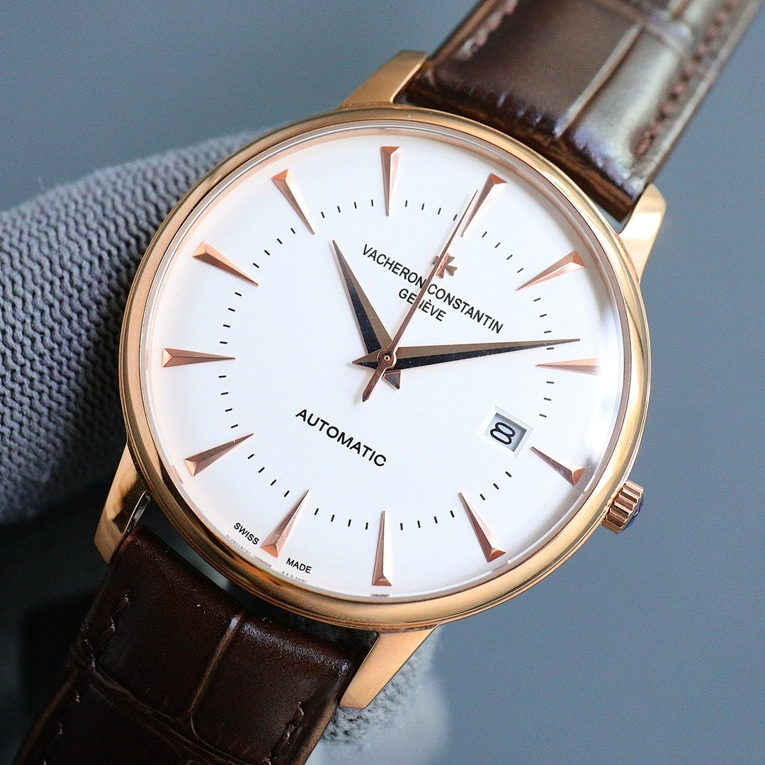 Gold-tone automatic wristwatch with white dial, brown leather strap, gold hands and date window.