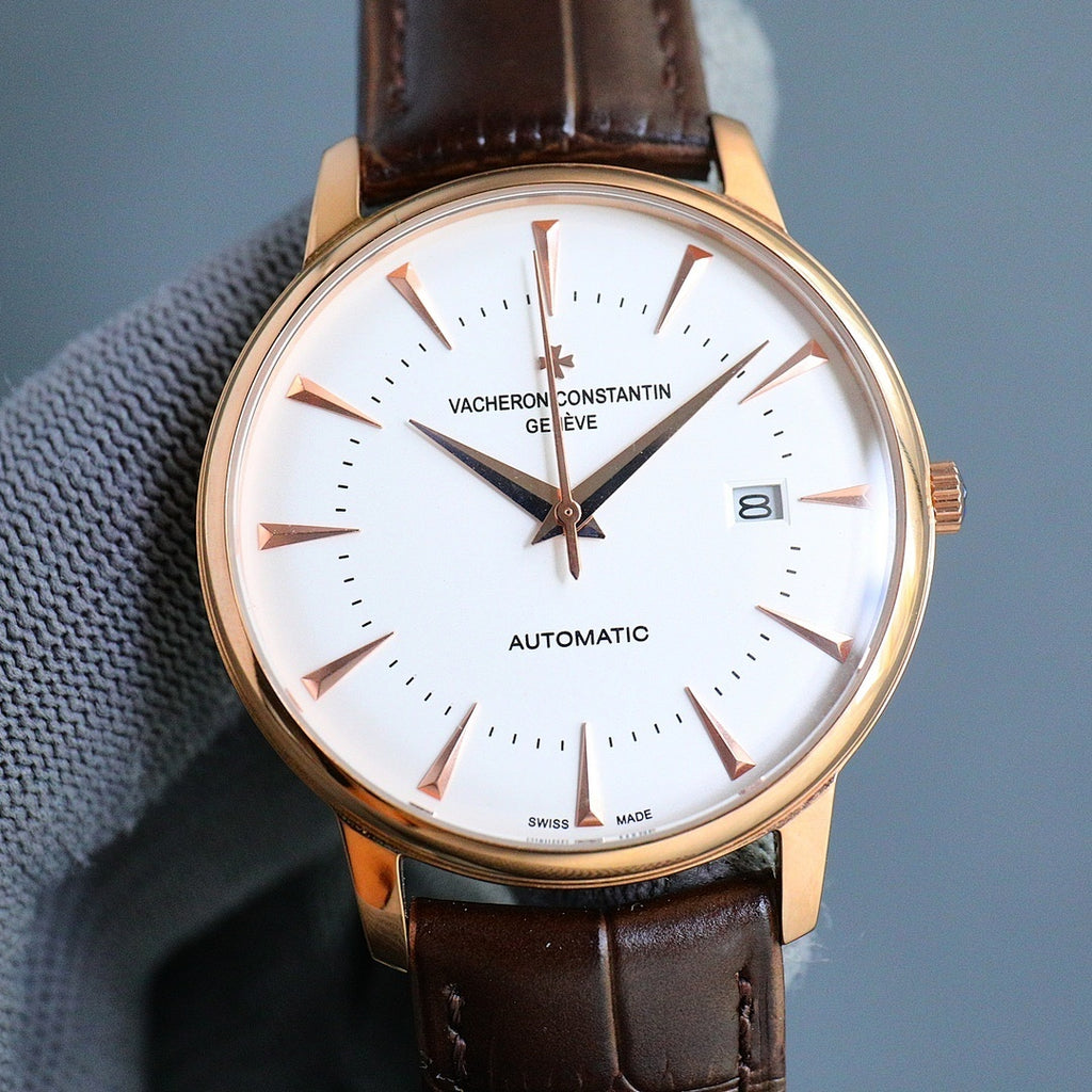 Gold-tone automatic wristwatch with white dial, brown leather strap, gold hands and markers, date window.