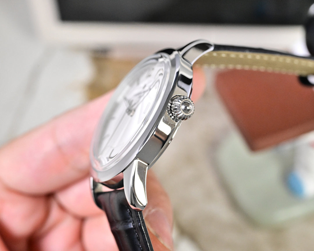 Wristwatch side profile with crown and silver case, black leather strap