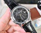 Wristwatch with black dial, silver case, and black leather strap, three-quarter view