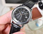 Wristwatch with black dial and silver bezel, black leather strap, three-quarter view
