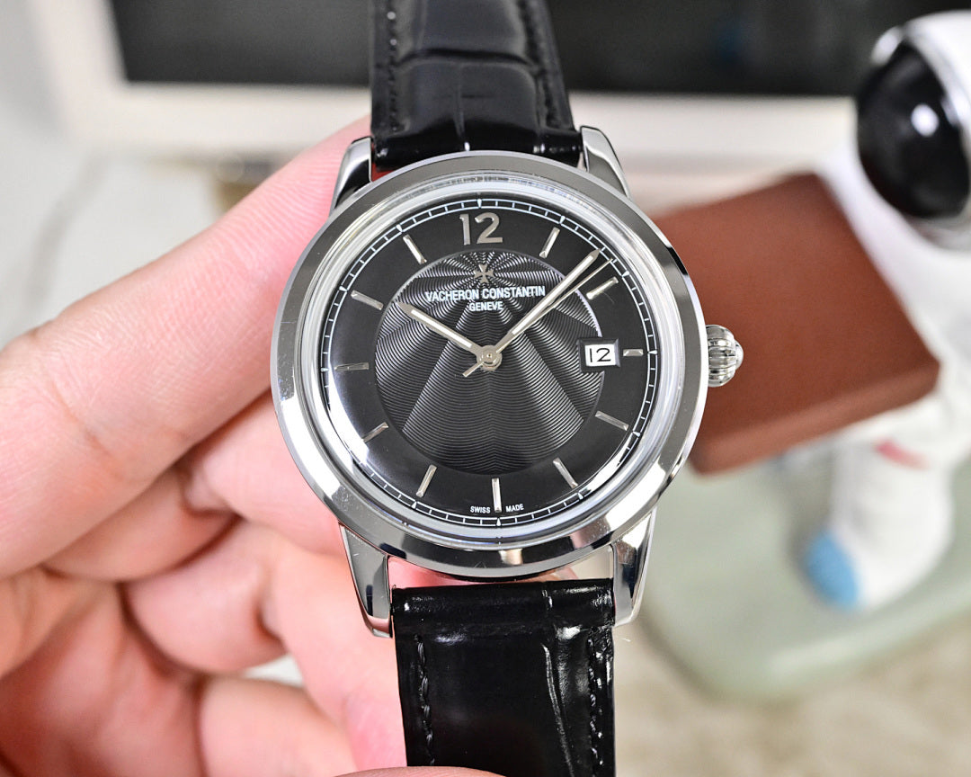 Wristwatch with dark dial, silver case, and black leather strap