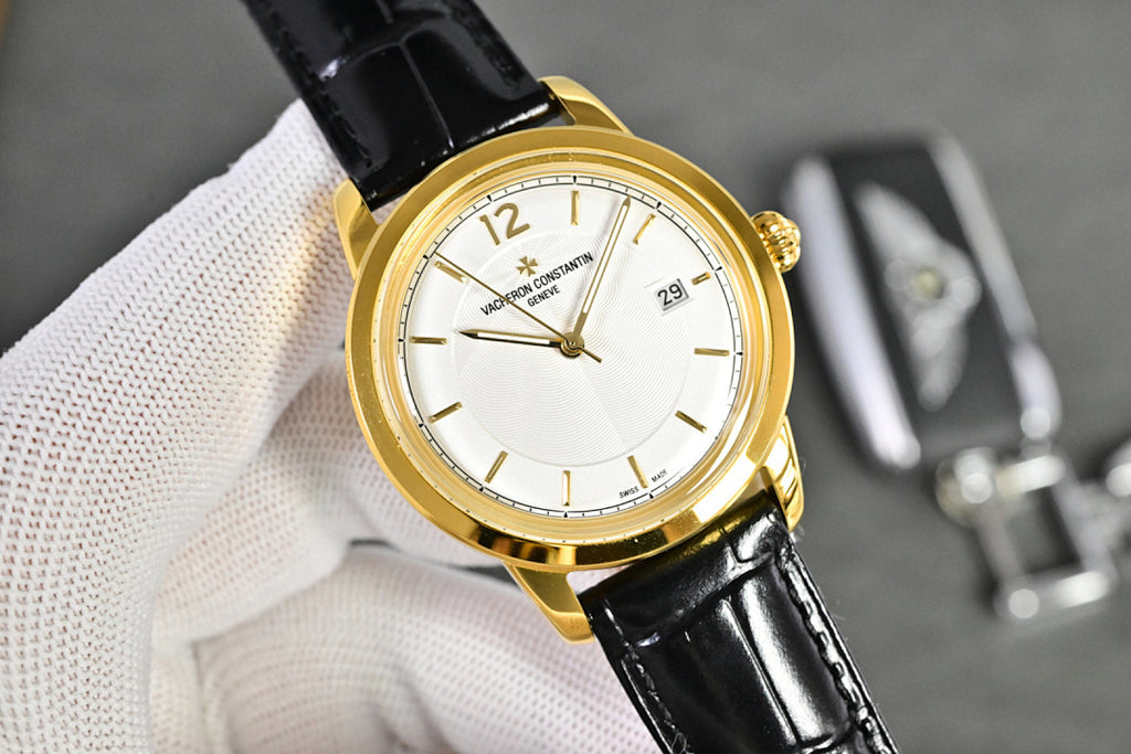Vacheron Constantin watch with gold-tone case, white dial, black leather strap