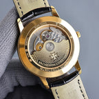 Vacheron Constantin watch caseback with visible movement, gold-toned case, black leather strap
