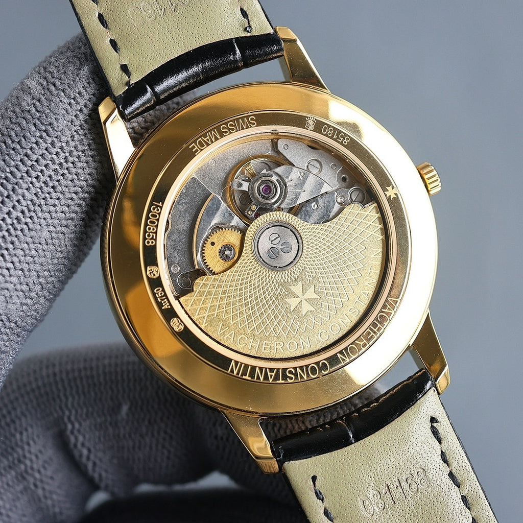 Vacheron Constantin wristwatch back with exposed movement, gold case, leather strap.