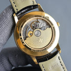 Vacheron Constantin wristwatch back with exposed movement, gold case, leather strap.