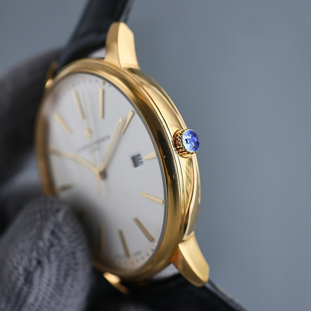 Vacheron Constantin wristwatch side: gold case, black strap, blue crown, white dial.