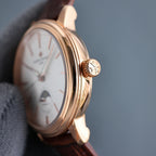 Vacheron Constantin gold-tone watch with brown leather strap, crown detail and white dial