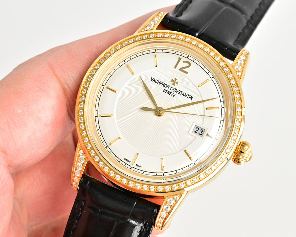 Gold-tone wristwatch with diamond bezel, black leather strap, white dial