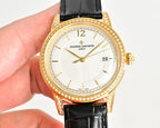Gold-tone wristwatch with diamond bezel, black leather strap, white dial and date