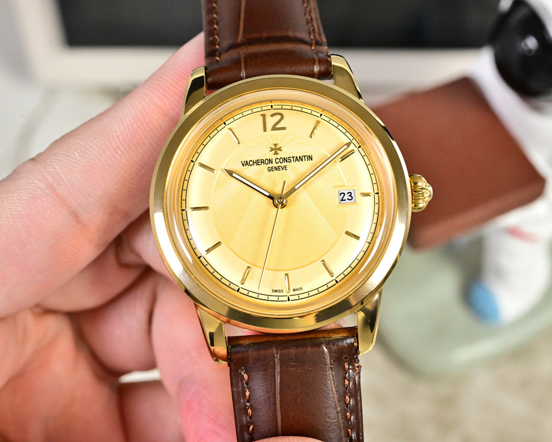 Gold-tone wristwatch with yellow dial and brown leather strap