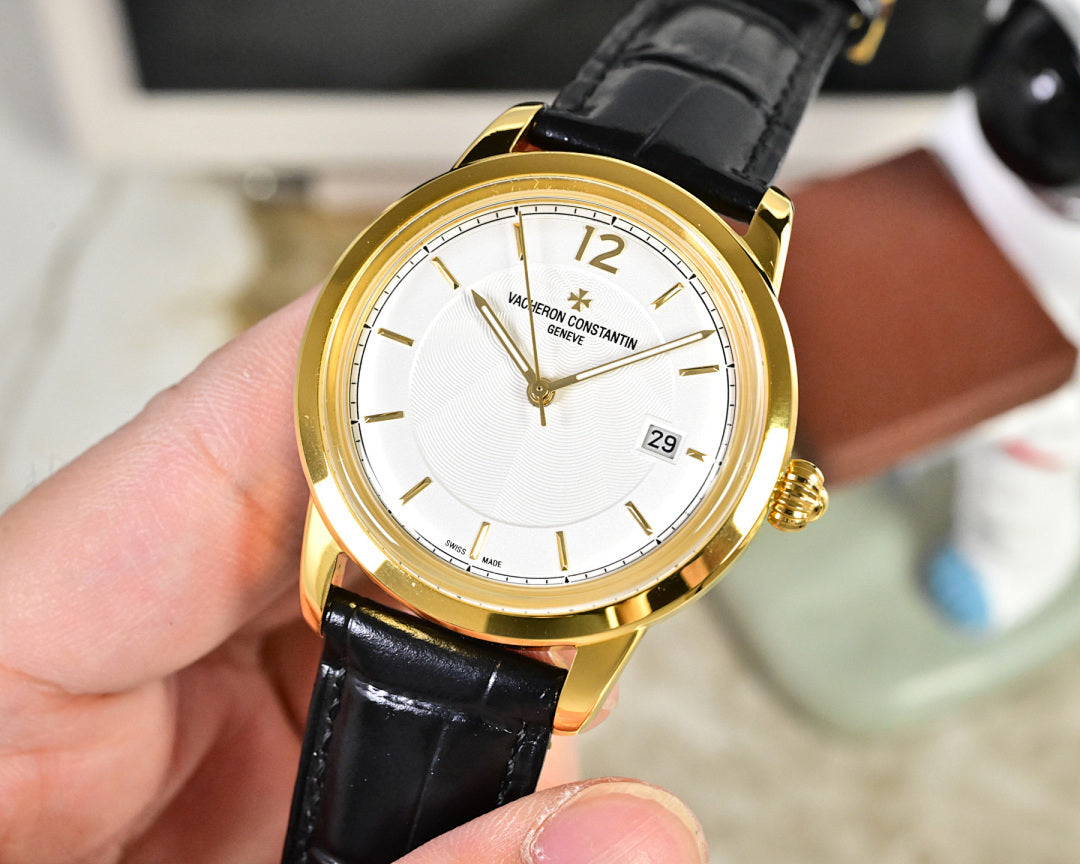 Gold-tone wristwatch with white dial and black leather strap, front view