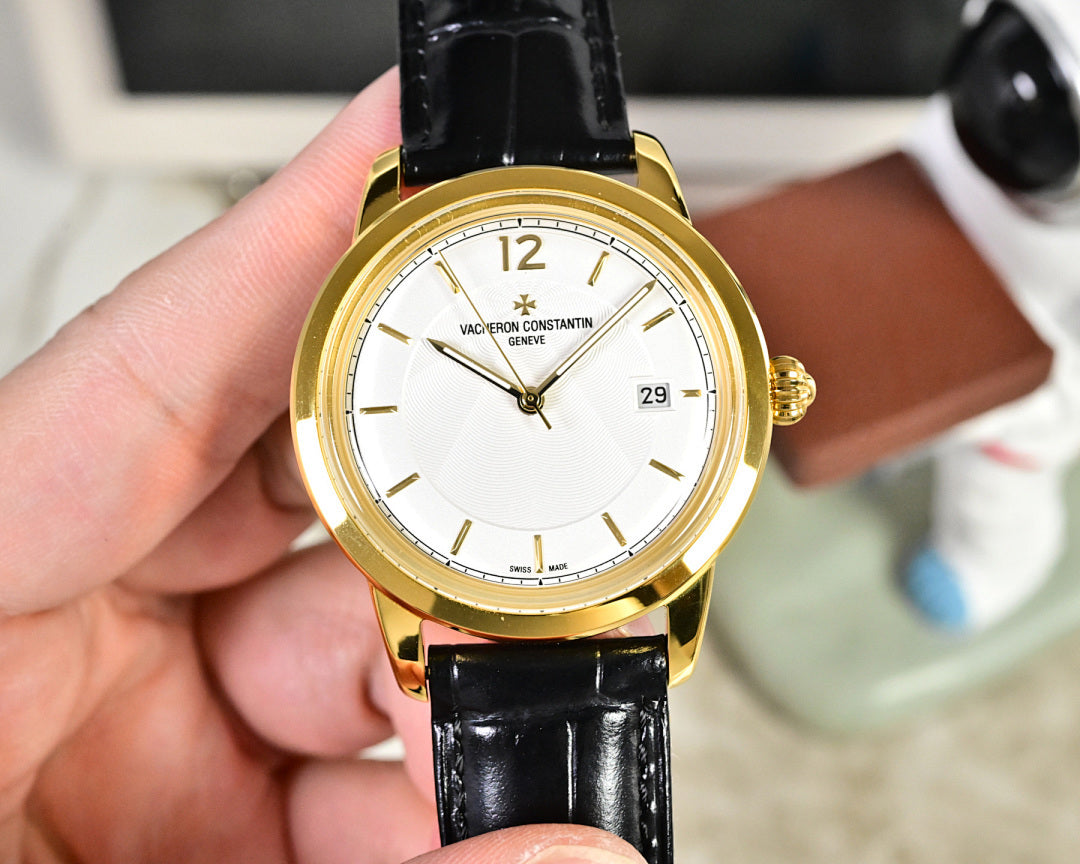 Gold-tone wristwatch with white dial and black leather strap
