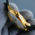 Vacheron Constantin watch side view with gold case and black leather strap
