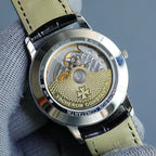 Skeleton caseback with detailed movement and gold-toned parts on leather strap